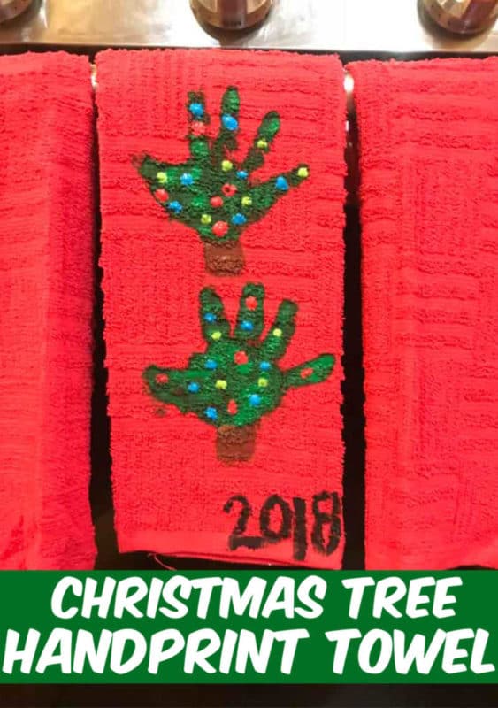 handprint Christmas Tree towel hanging on the stove door in the kitchen