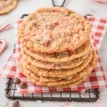 A stack of peppermint chocolate chip cookies on a cooling rack.