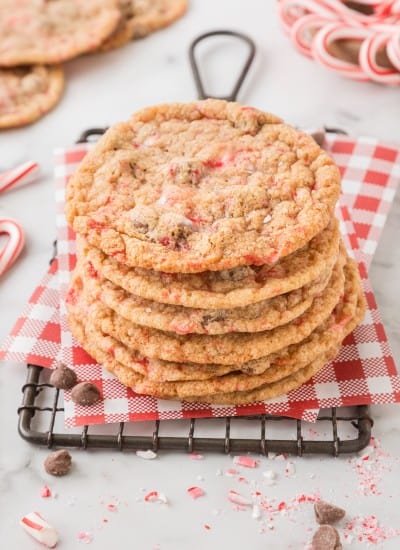 A stack of peppermint chocolate chip cookies on a cooling rack.