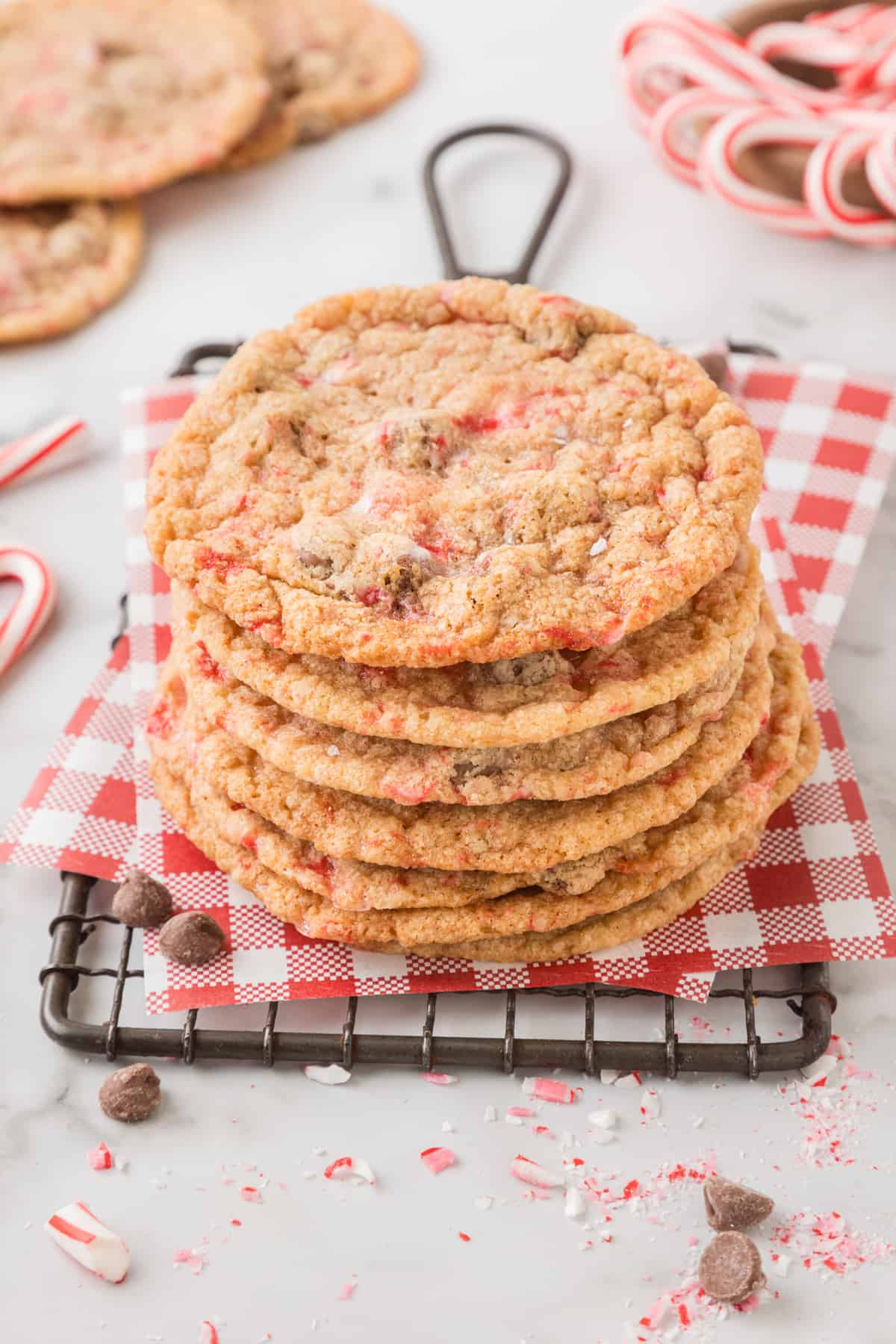 A stack of peppermint chocolate chip cookies on a cooling rack.
