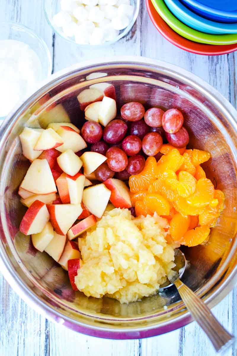 Bowl of fruit prepped to make fruit salad, bowl is filled with mandarin oranges, grapes, apples and pineapples!