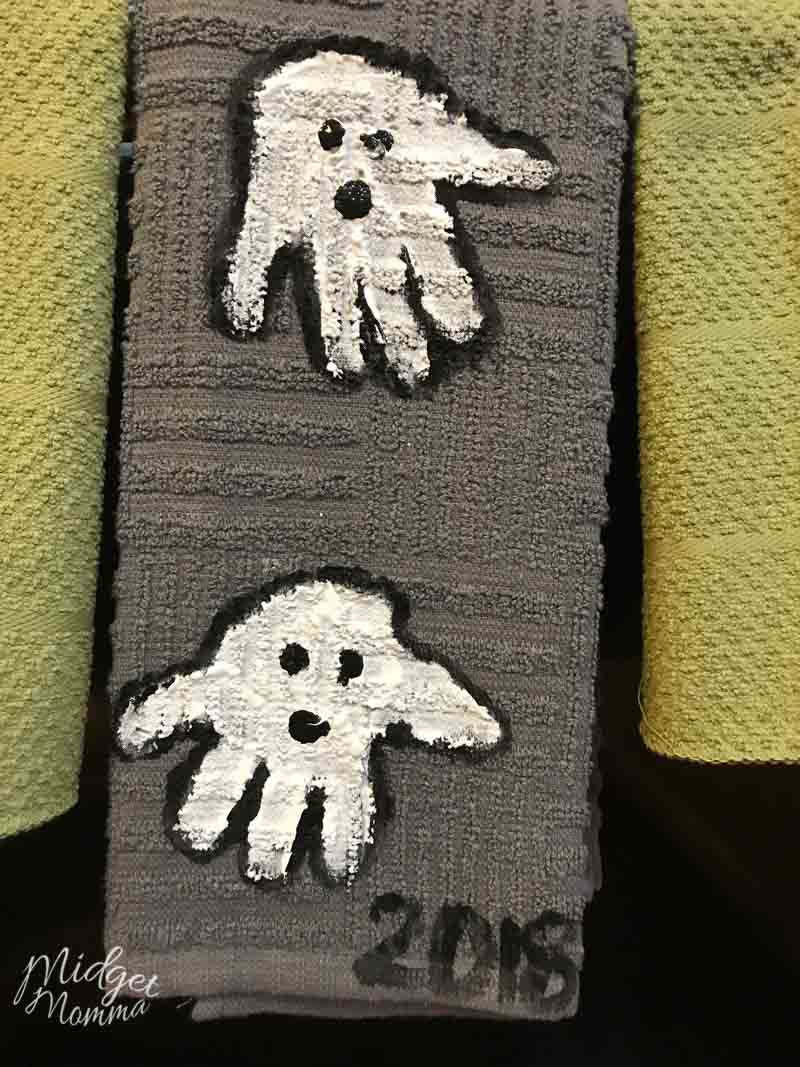 kids handprint ghost towels hanging on the stove