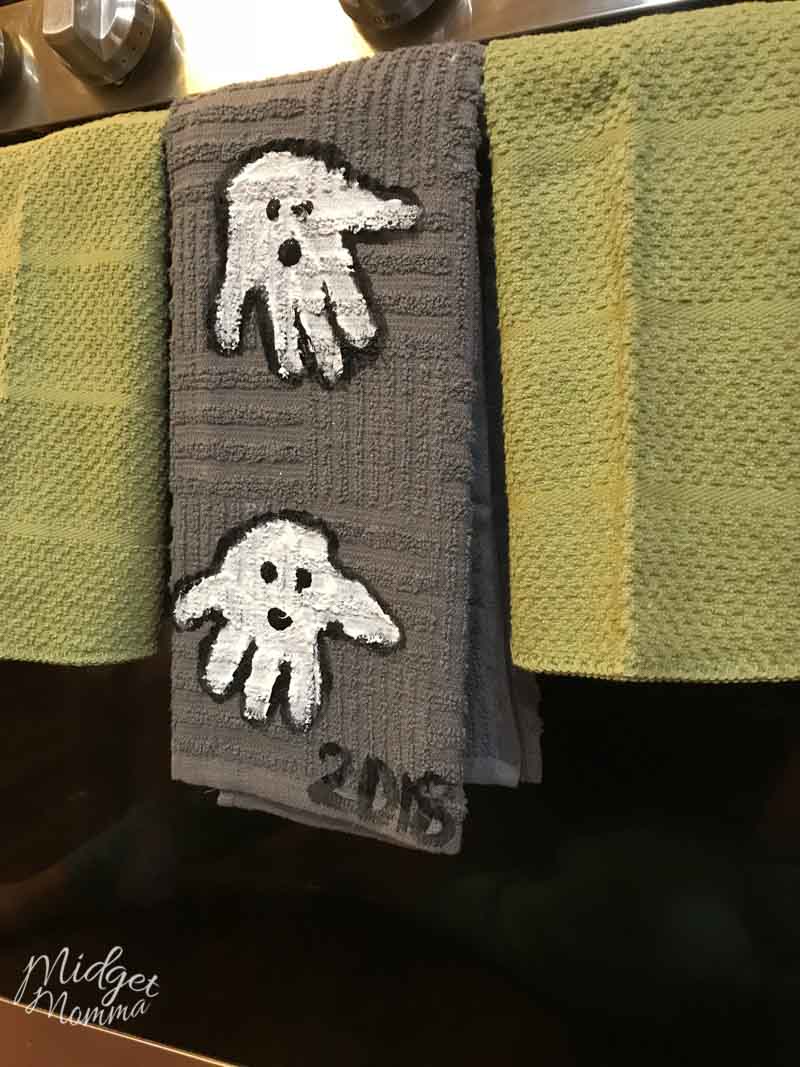 Kids handprint ghost towels hanging on the stove
