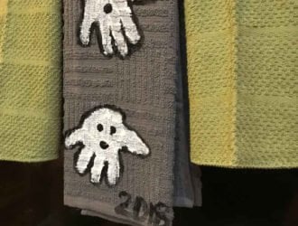 These handprint ghost towels are the perfect Halloween Decoration for your kitchen. Using handtowels, paint and your kids hands you can make this adorable handprint Halloween craft with the kids that will be a keepsake forever.