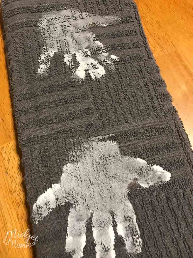 grey kitchen towel with kids handprints done with white paint