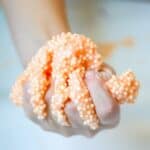 Kids hand filled with homemade floam slime