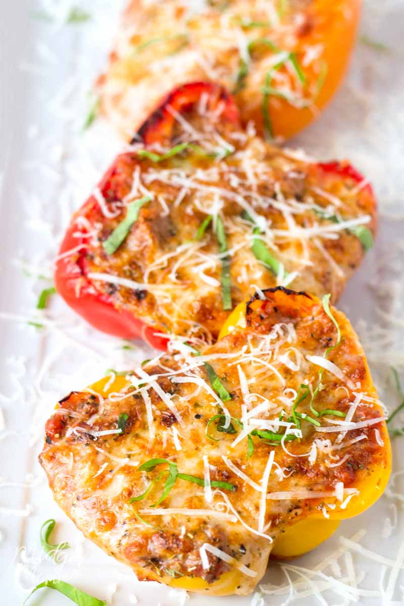 Low Carb Stuffed Peppers Recipe - Lasagna Stuffed Peppers on a plate with red and yellow peppers