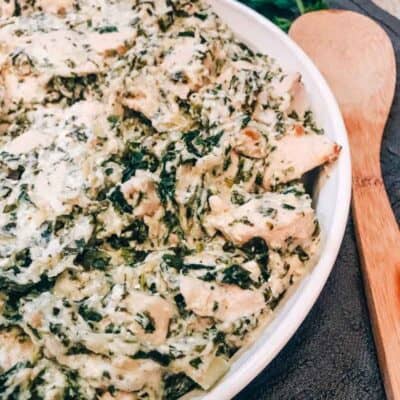 Casserole dish filled with spinach artichoke chicken casserole