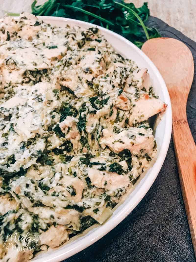 Casserole dish filled with spinach artichoke chicken casserole