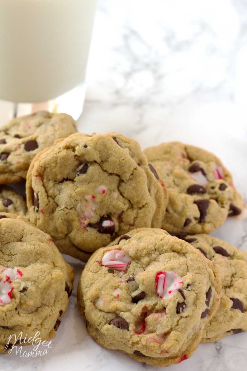 Soft Peppermint Chocolate Chip Cookies in a heaping pile, made with peppermint chips and chocolate chips along with a cold glass of milk.