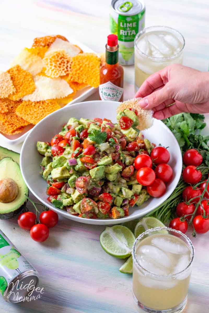 WOW Your family and friends with this amazing spicy avocado dip! A simple dip recipe, made with fresh ingredients including avocados and tomatoes. Perfect for taco night dinner or a game day snack! #SavorWinningFlavors #AvocadosFromMexico #HAVEARITA AND #FlavorYourWorld