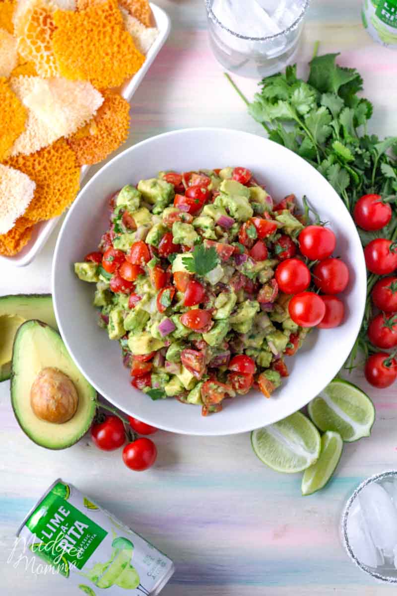 WOW Your family and friends with this amazing spicy avocado dip! A simple dip recipe, made with fresh ingredients including avocados and tomatoes. Perfect for taco night dinner or a game day snack! #SavorWinningFlavors #AvocadosFromMexico #HAVEARITA AND #FlavorYourWorld