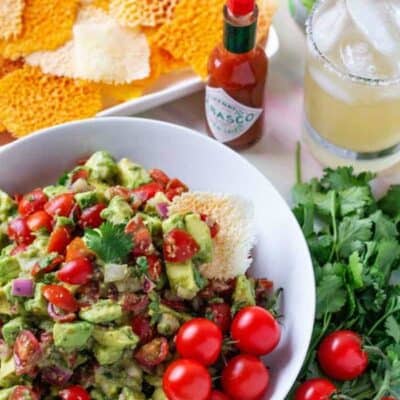 WOW Your family and friends with this amazing spicy avocado dip! A simple dip recipe, made with fresh ingredients including avocados and tomatoes. Perfect for taco night dinner or a game day snack! #SavorWinningFlavors #AvocadosFromMexico #HAVEARITA AND #FlavorYourWorld