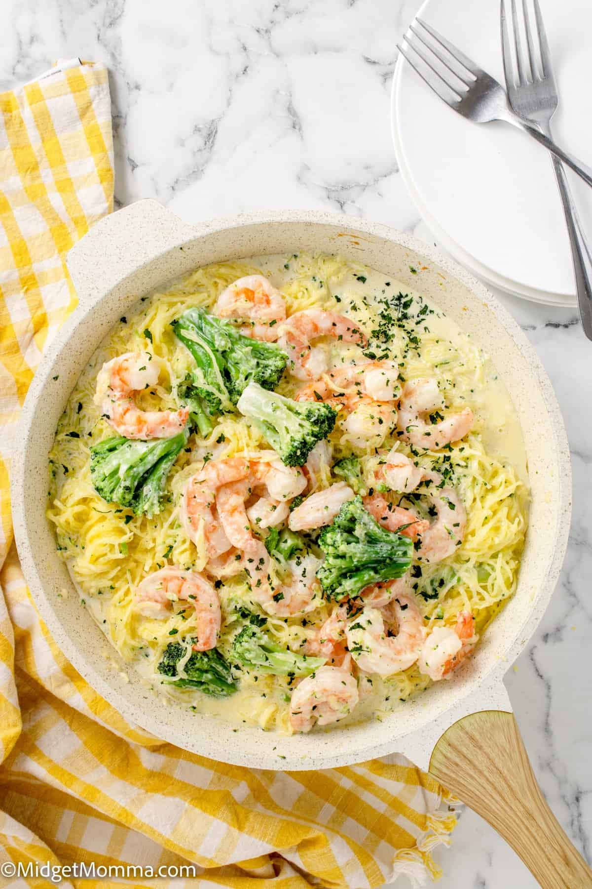 Shrimp, alfredo sauce, and spaghetti squash mixed together in a skillet