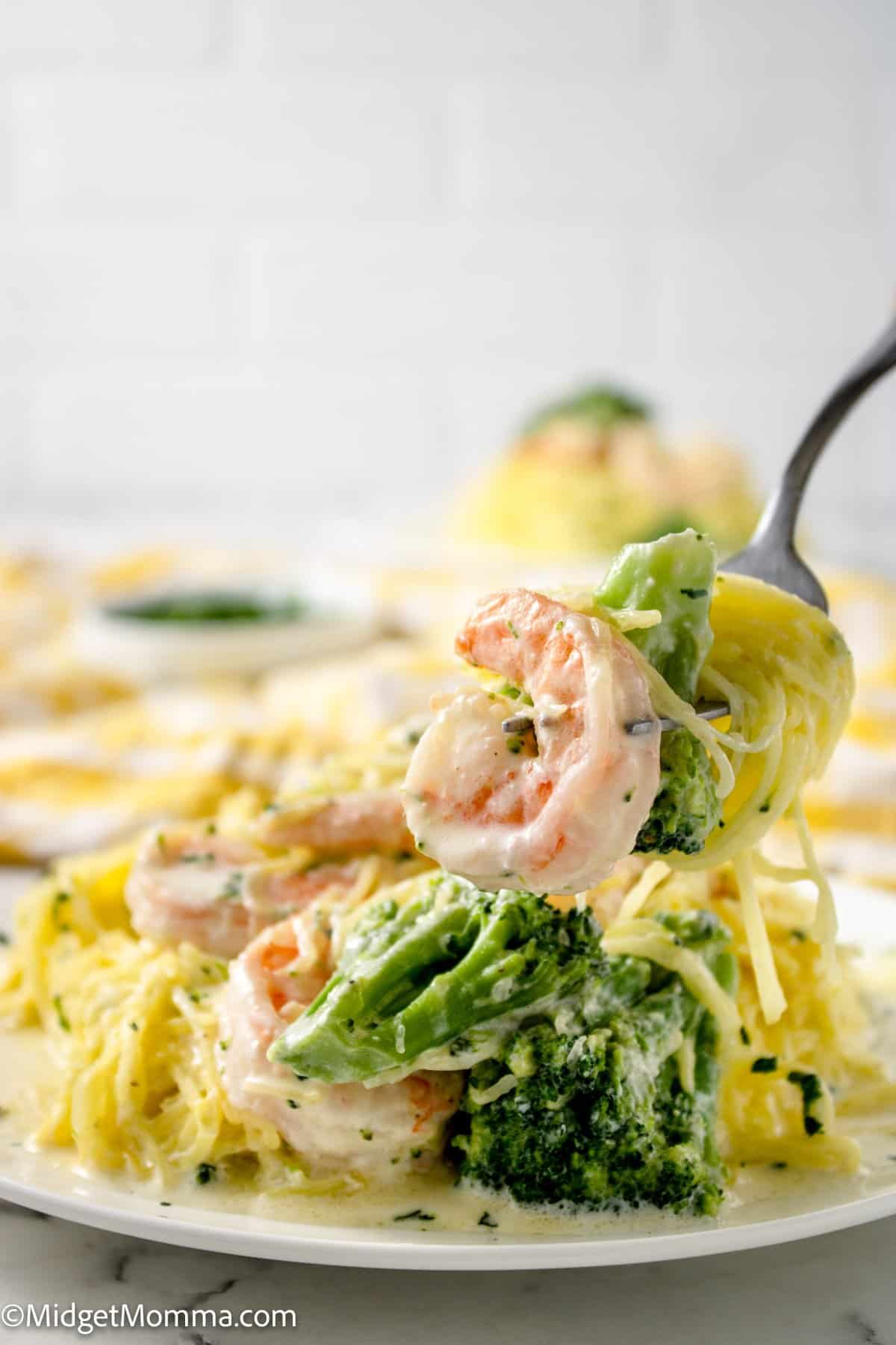 Shrimp Alfredo Spaghetti Squash with Broccoli close up photo with a fork taking a fork full of the dish