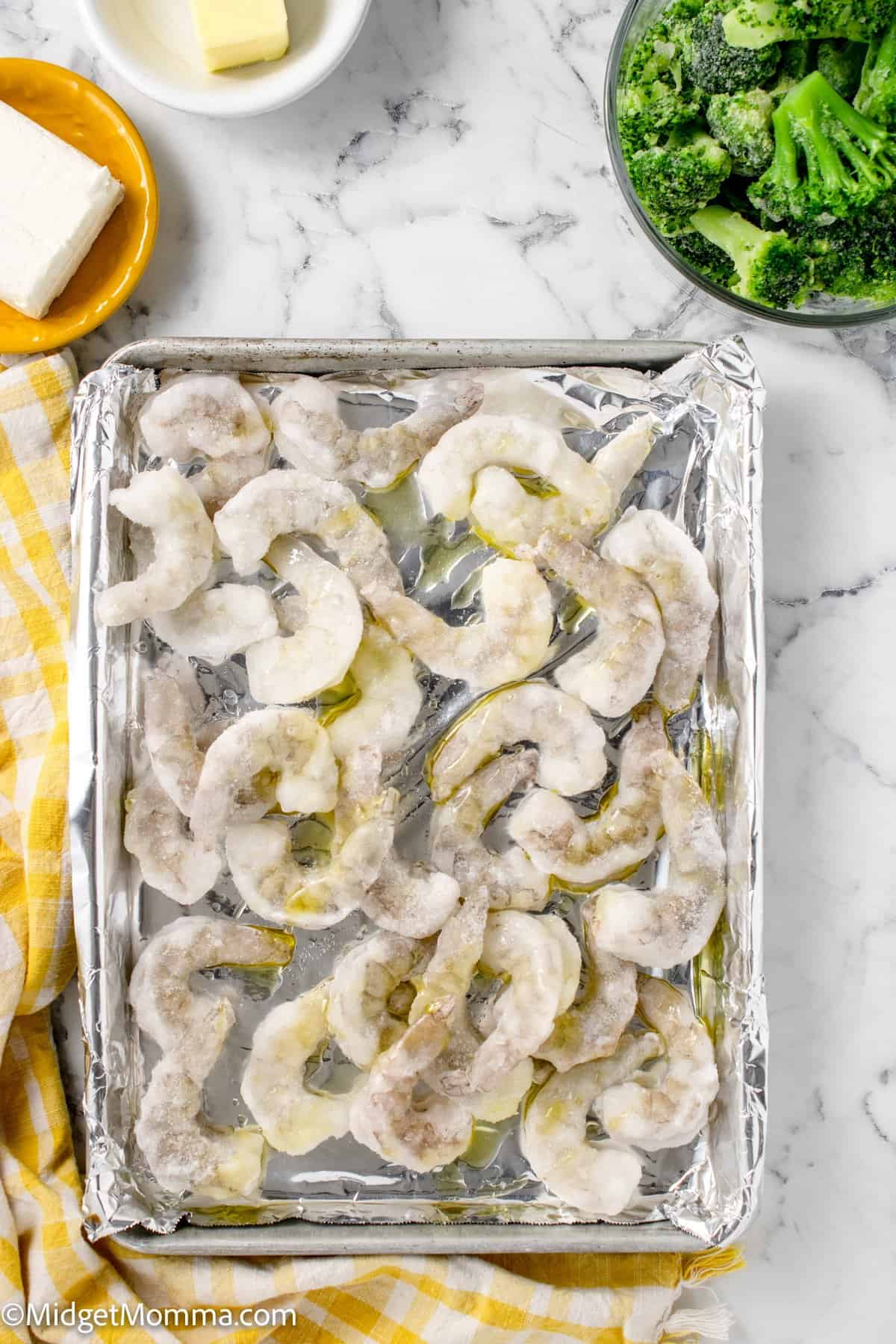 raw shrimp on a baking sheet lined with tinfoil