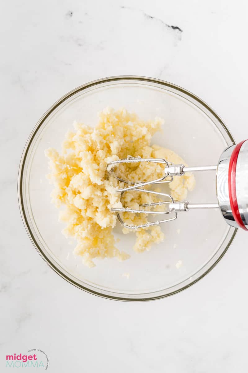 butter and sugar being combined in a bowl