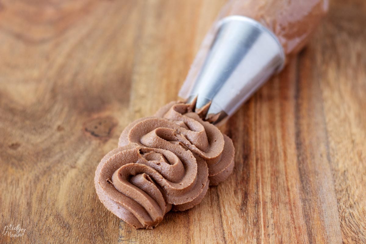 smooth keto chocolate buttercream squeezing out of a piping bag