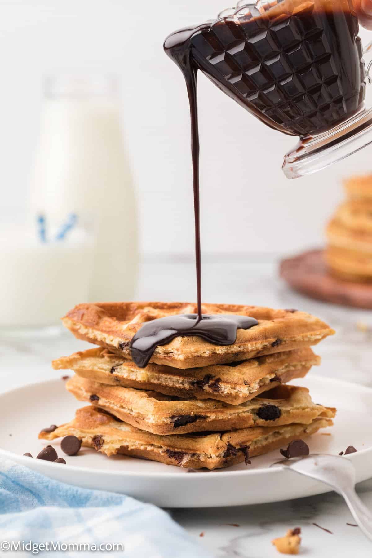 chocolate sauce drizzled on top of a stack of Chocolate Chip waffles