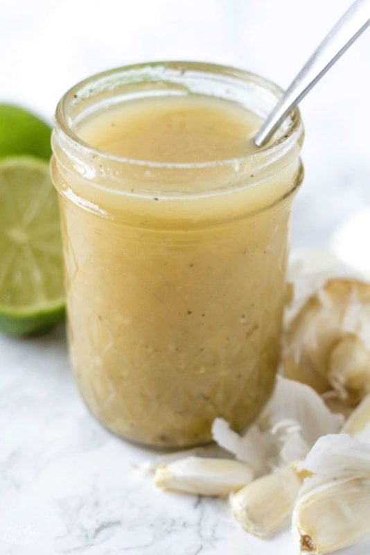 Garlic Lime Vinaigrette Salad dressing in a mason jar on the kitchen counter