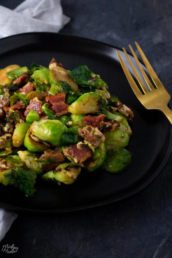 Cheesy Brussel Sprouts with bacon on a black plate