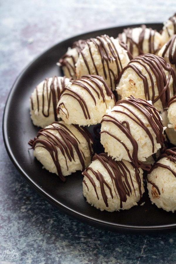 coconut balls drizzled with sugar free chocolate one a plate