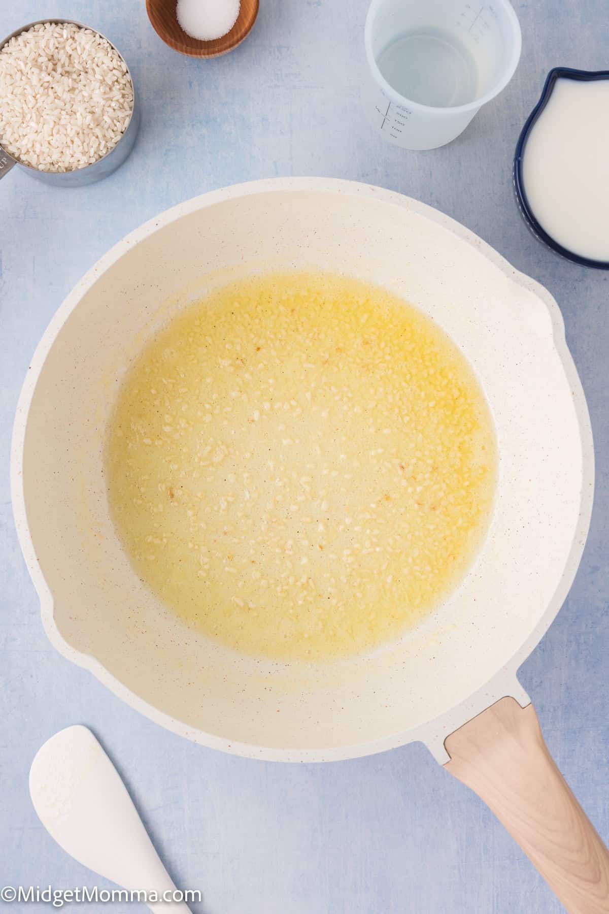 a skillet with melted butter cooking garlic 