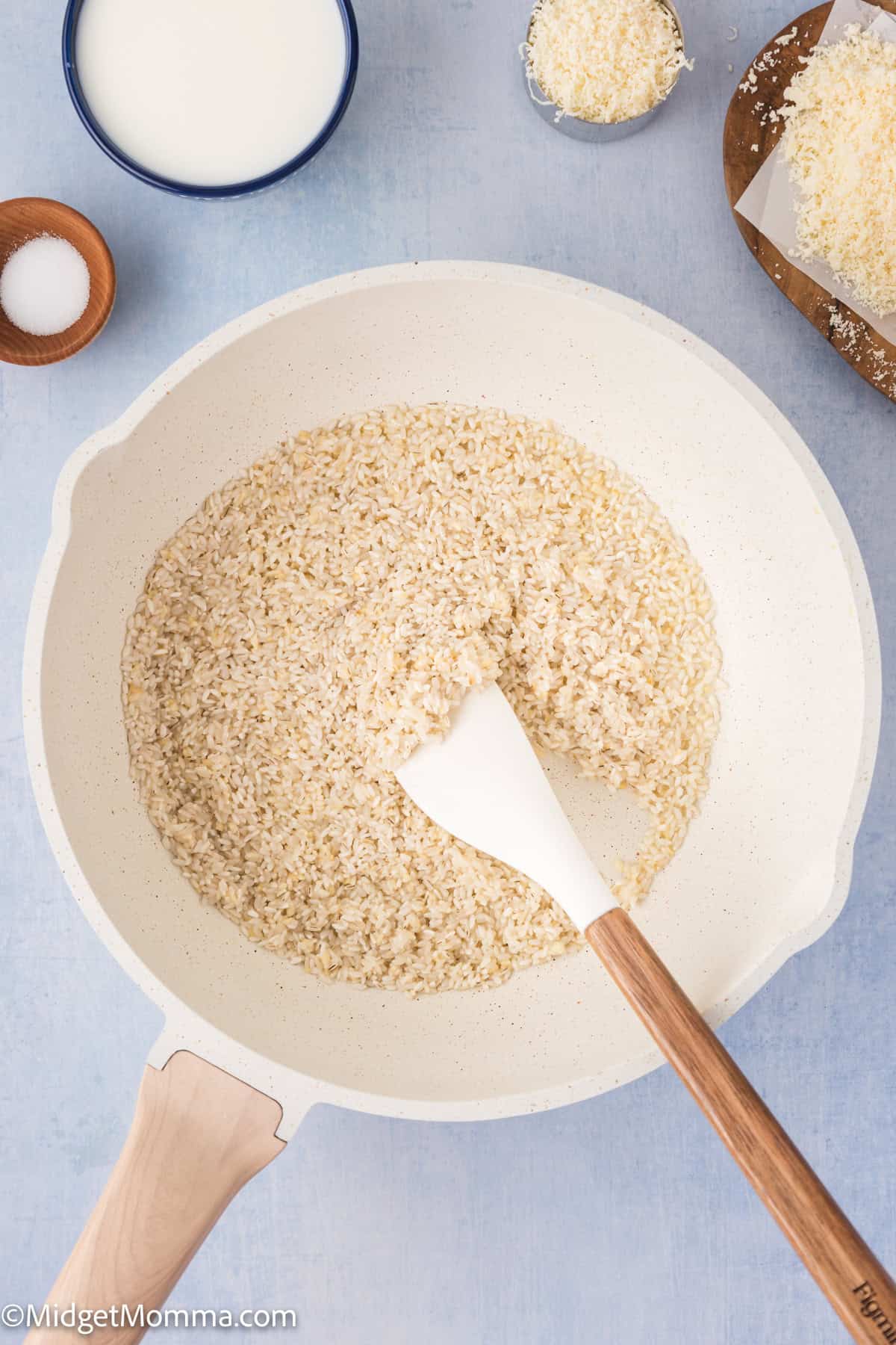 rice added to a saucepan with butter and sautéed garlic