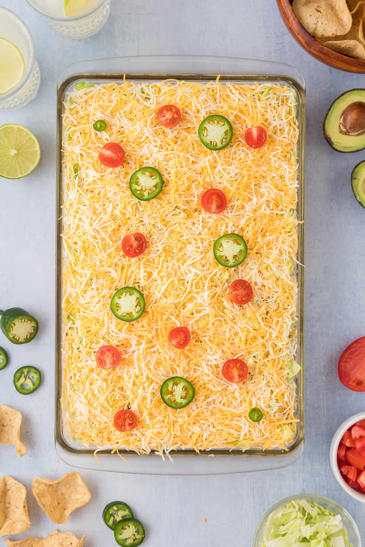 Finished layered taco dip in a casserole dish