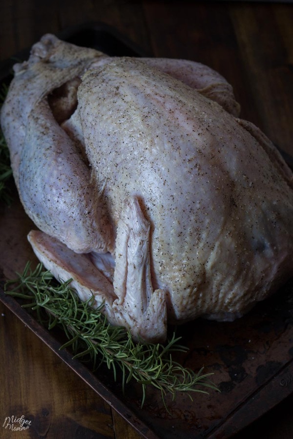 How to Dry Brine a Turkey- Raw turkey with dry brine rubbed on
