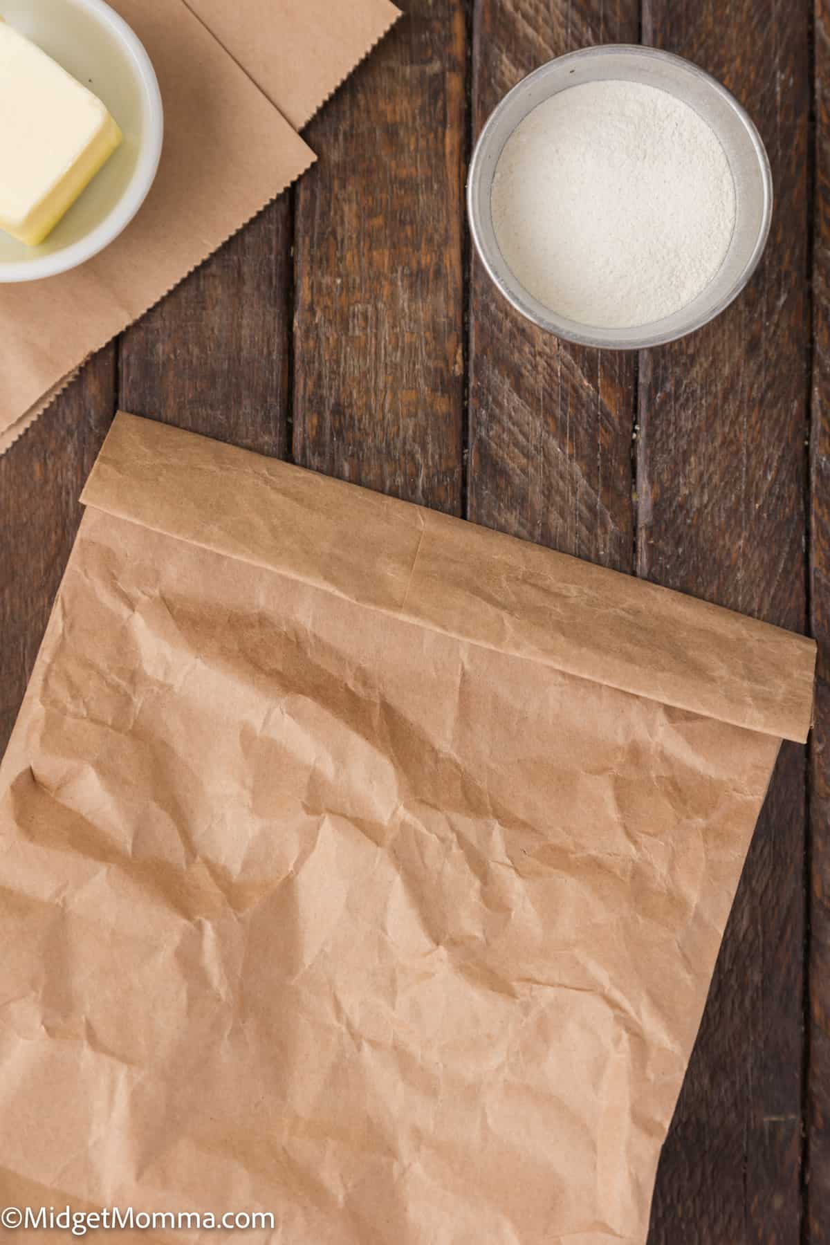 a brown paper bag filled with popcorn kernels folded closed