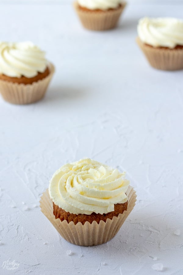 low carb vanilla cupcakes with caramel frosting and salt making the most amazing sugar free salted caramel cupcakes ever, sitting on the kitchen counter waiting to be eaten!