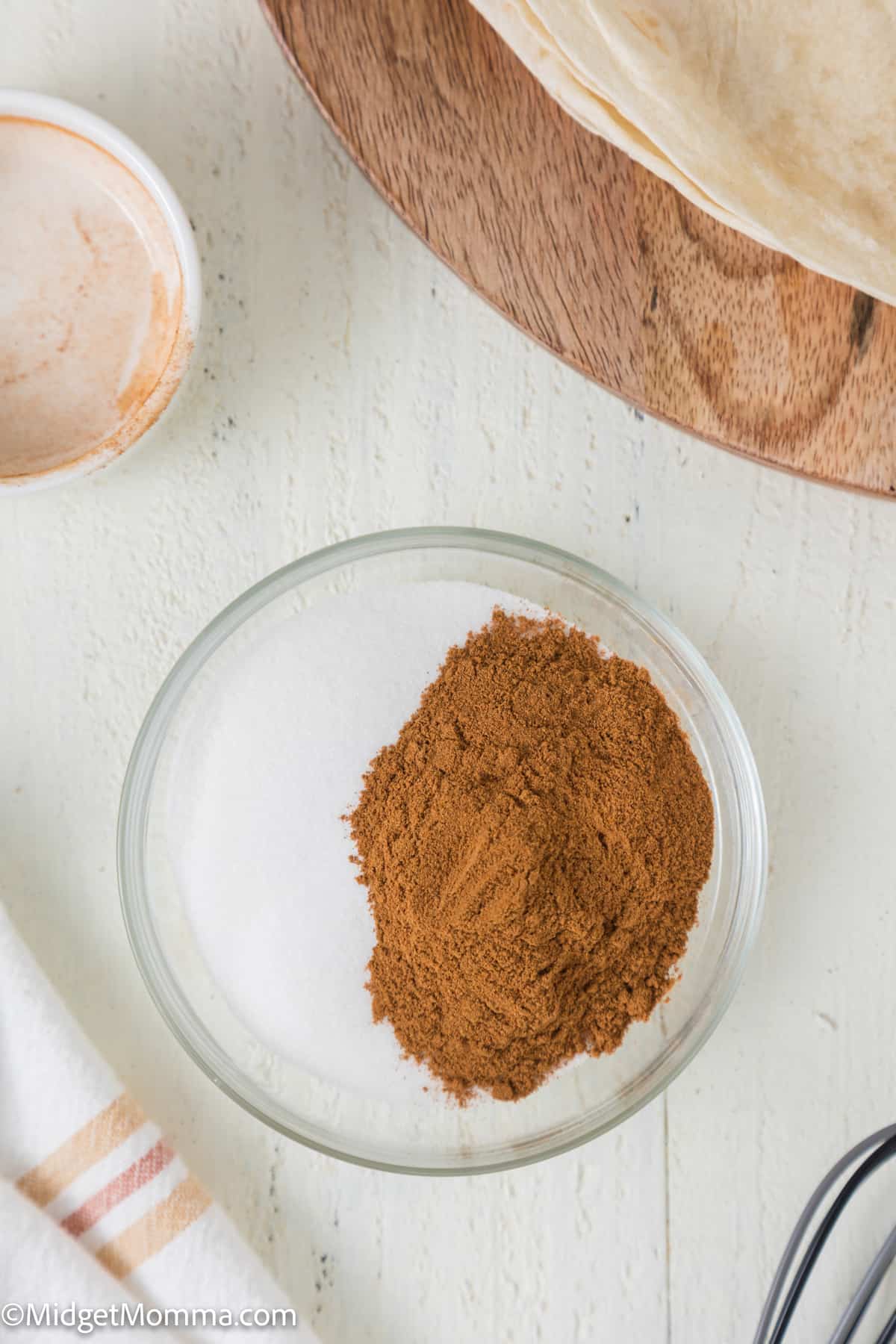 a bowl with cinnamon and sugar being mixed together