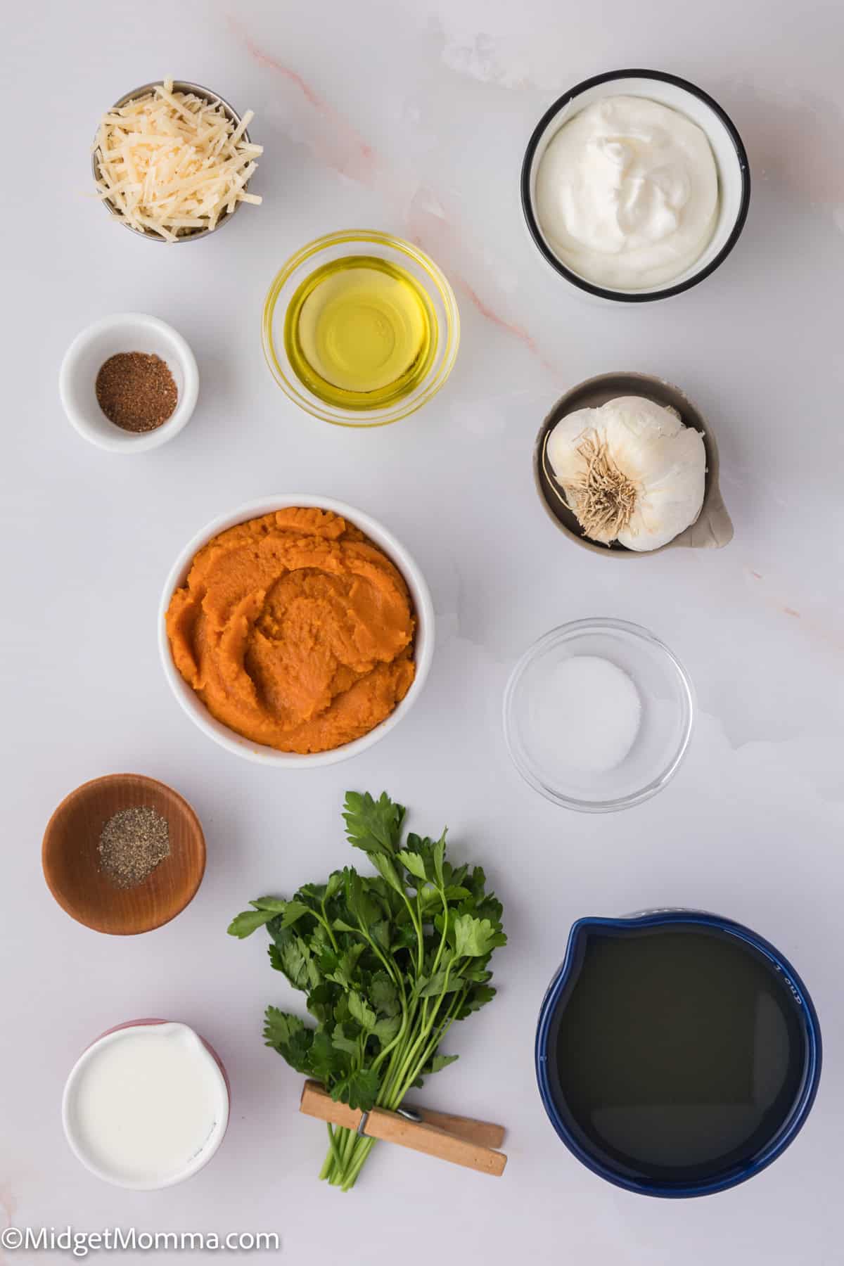 Pumpkin Pasta Sauce Recipe Ingredients. Various cooking ingredients arranged on a white surface, including bowls of spices, oils, dairy products, and fresh herbs.