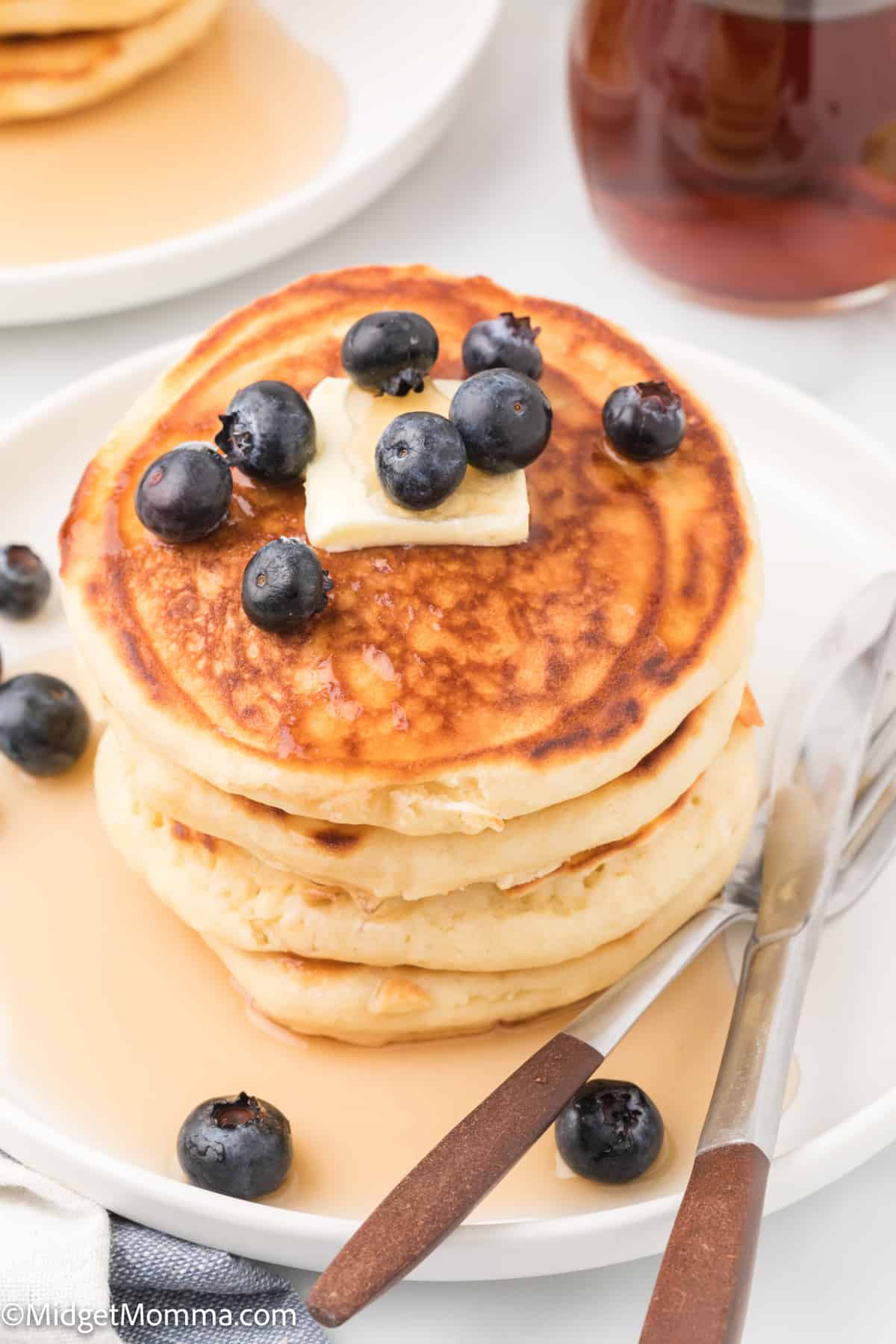 The Best Fluffy Homemade Pancakes Recipe topped with blueberries