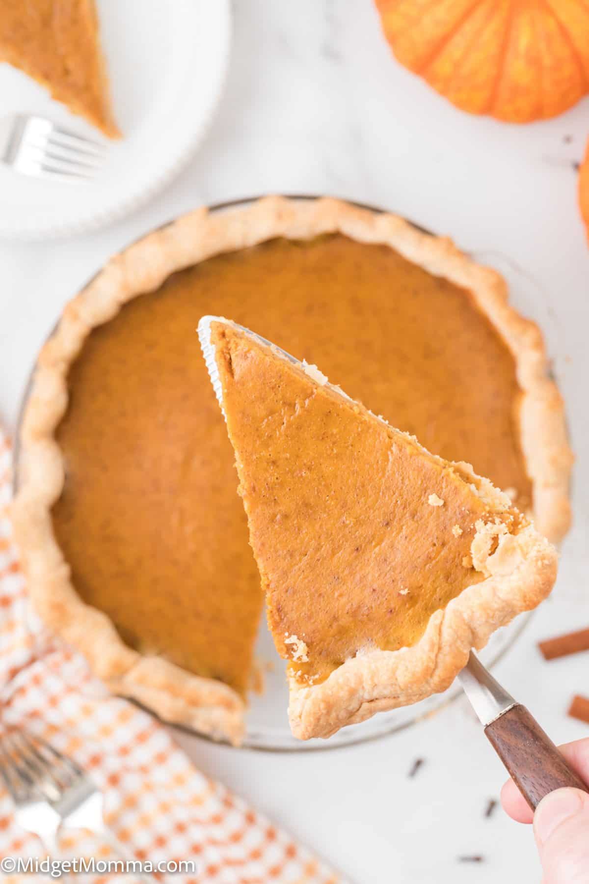 Slice of simple pumpkin pie recipe on a pie serving utensil.