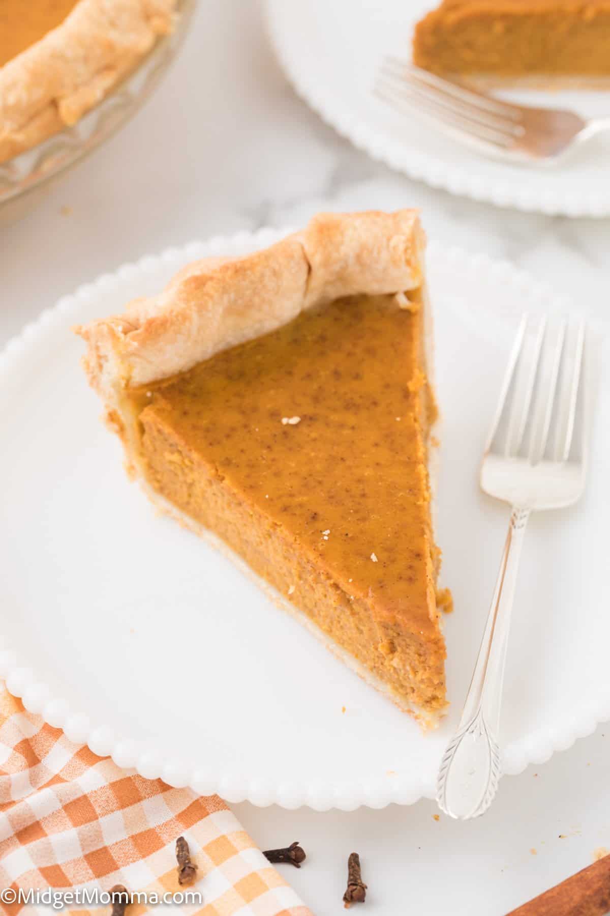 overhead photo of a slice of pumpkin pie on a plate.