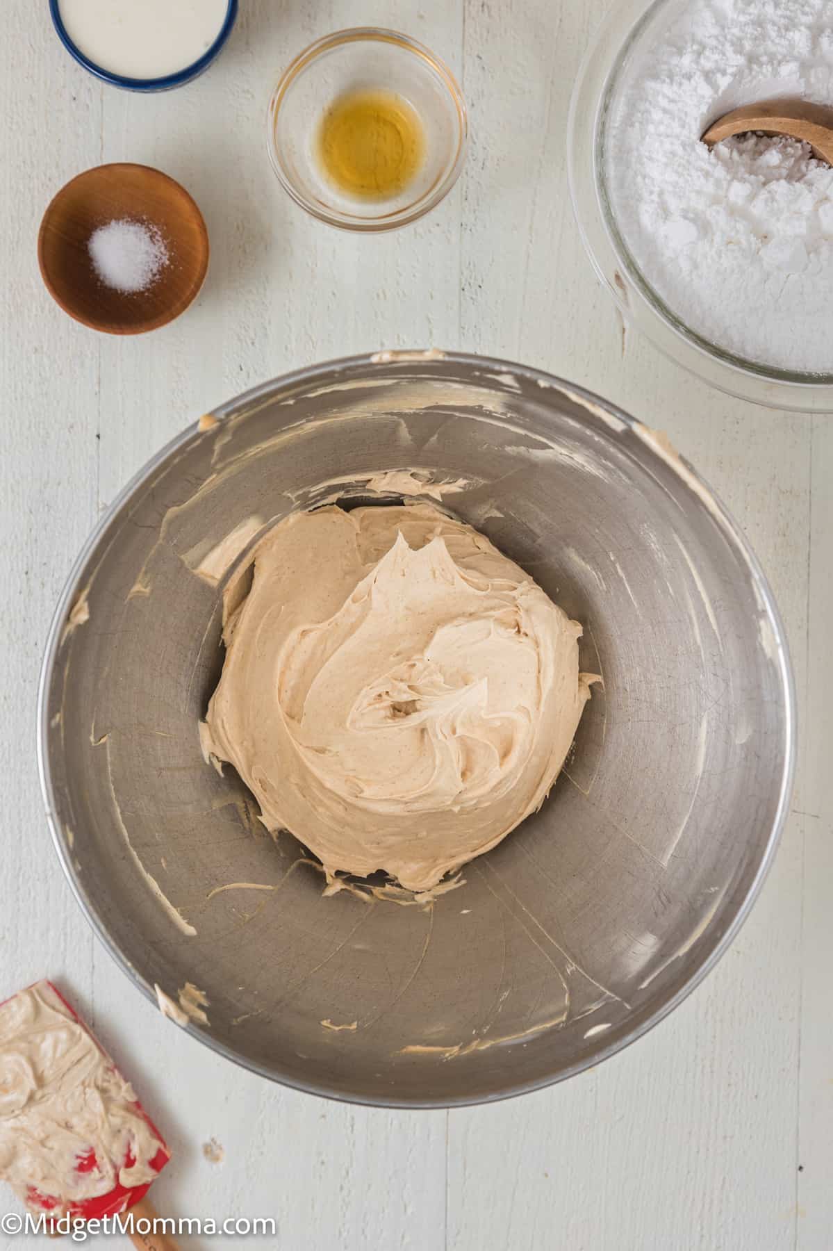 peanut butter and butter creamed together in a bowl of a stand mixer