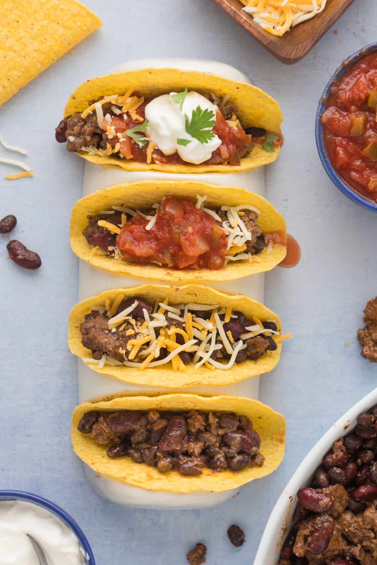 Mexican tacos made with slow cooker ground beef taco meat on a blue background.