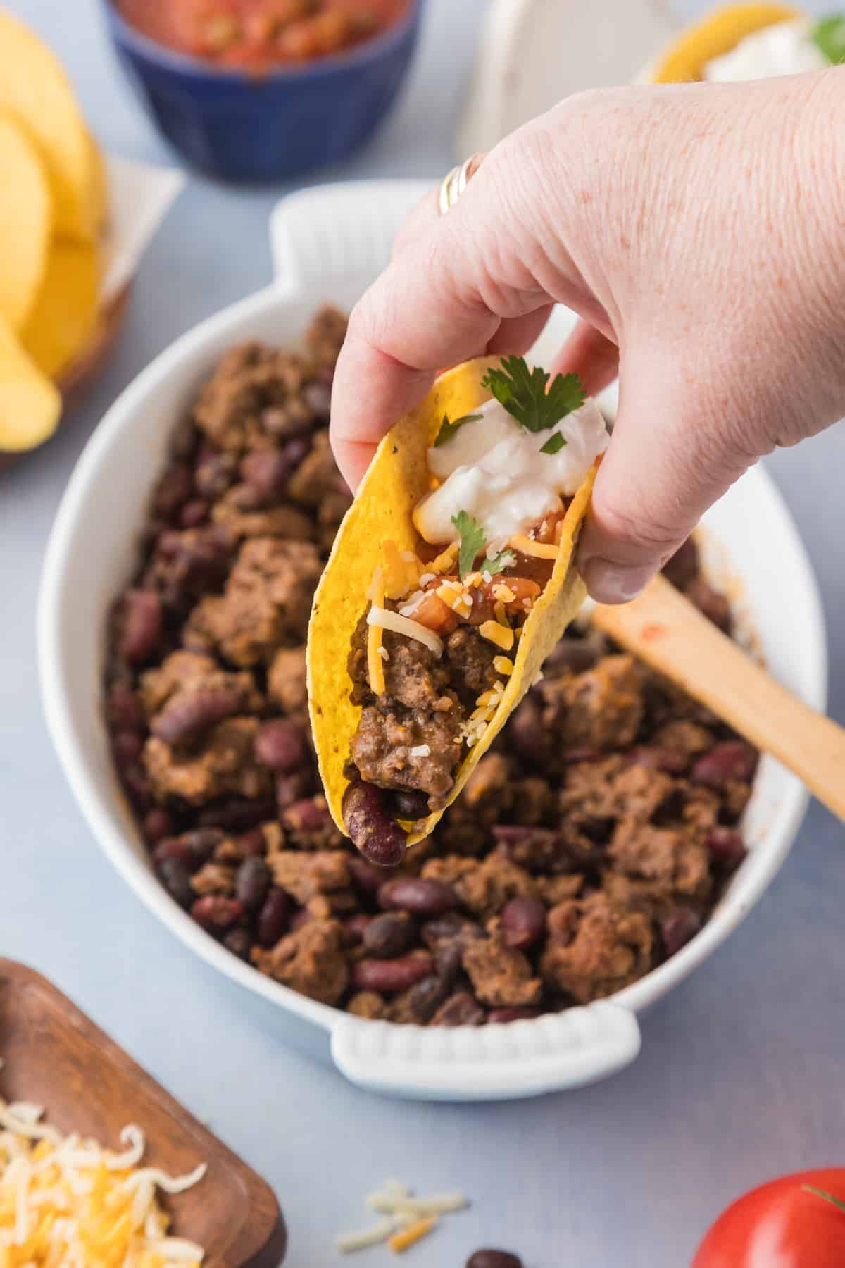 A person holding a taco