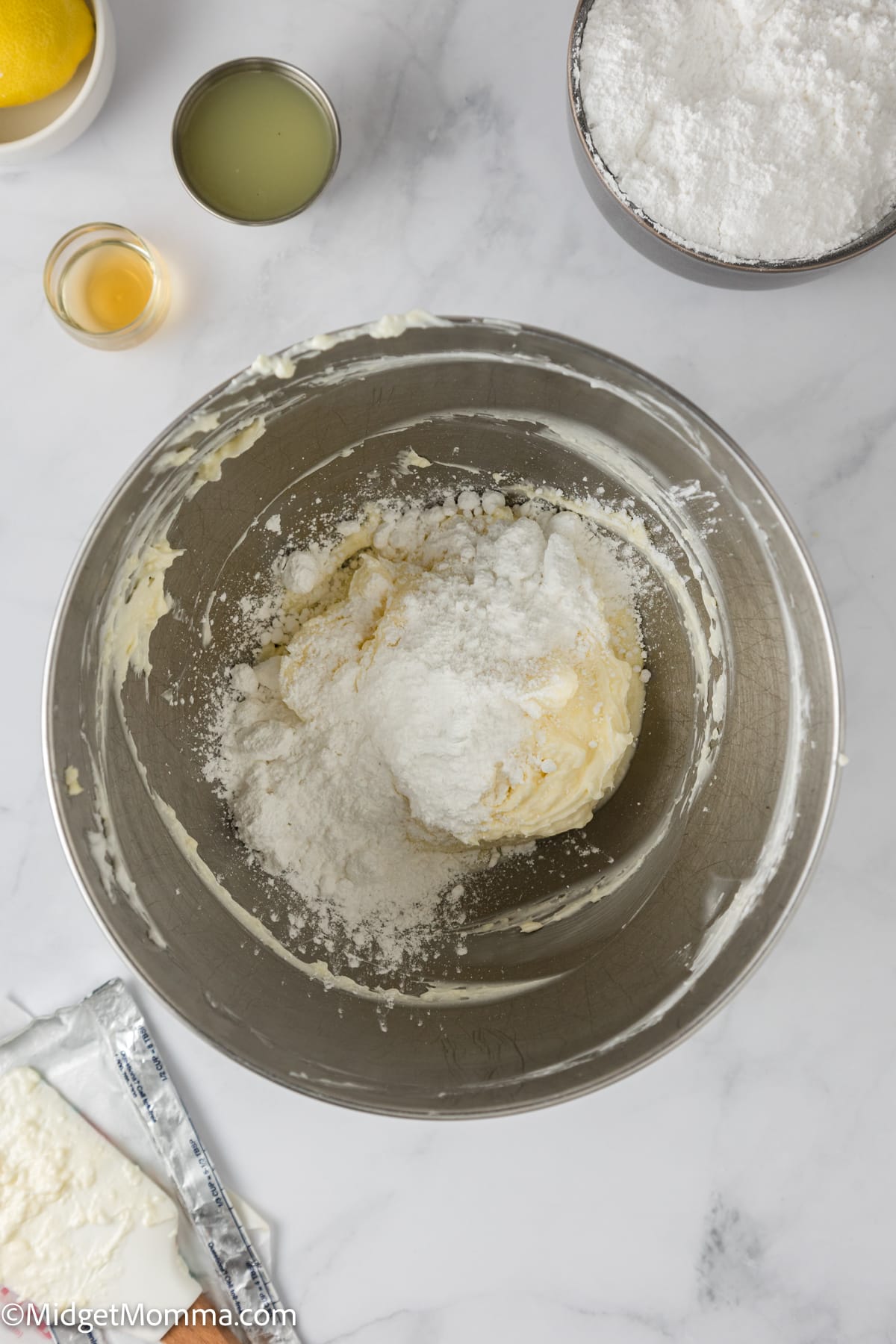 powdered sugar being added to the butter and shortening mixture