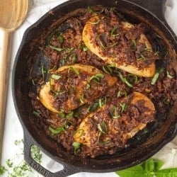 Tuscan chicken finished cooking in a skillet on the counter