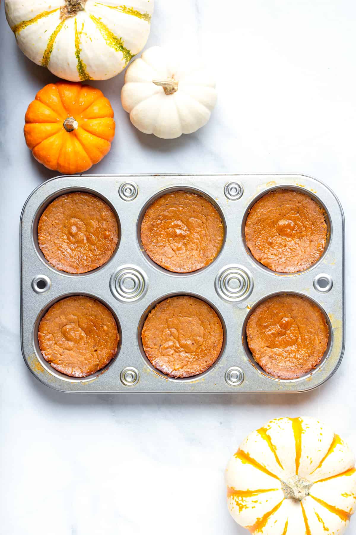 finished mini pumpkin pies in a muffin tin