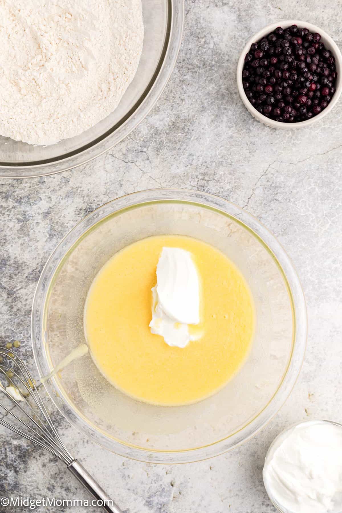 melted butter and greek yogurt added to the bowl of whisked eggs