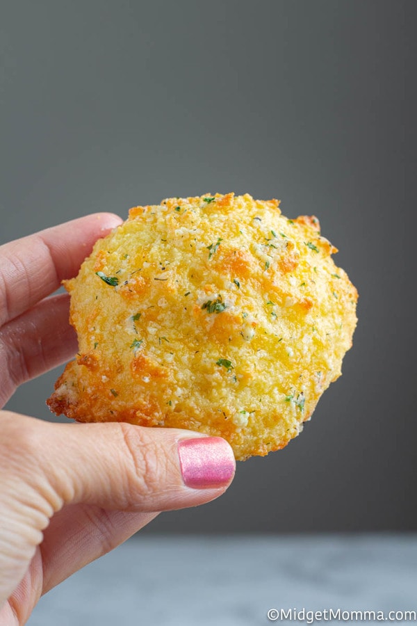 Keto Cheddar biscuit being held with a hand