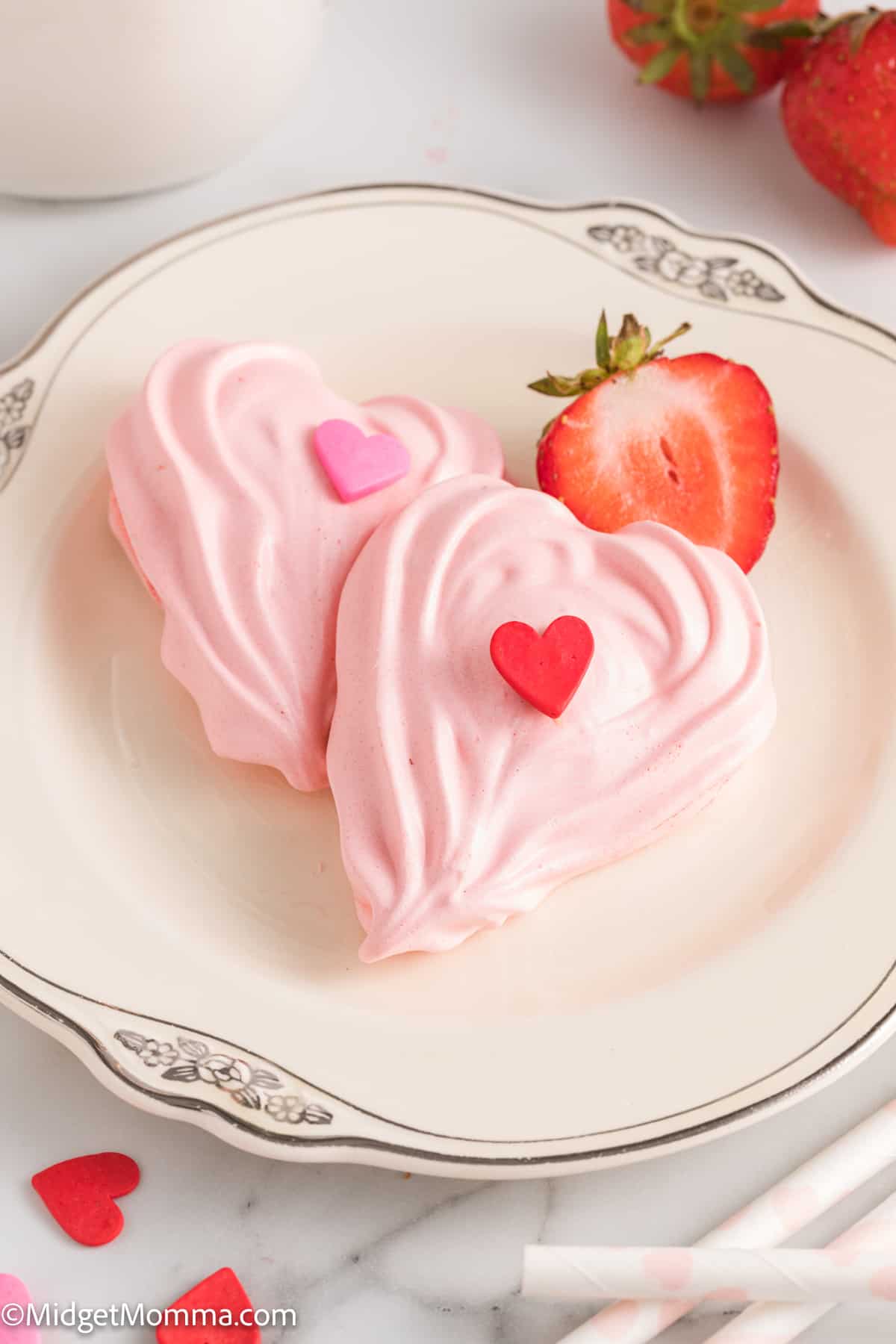 close up photo of 2 Strawberry Meringue Cookies on a plate