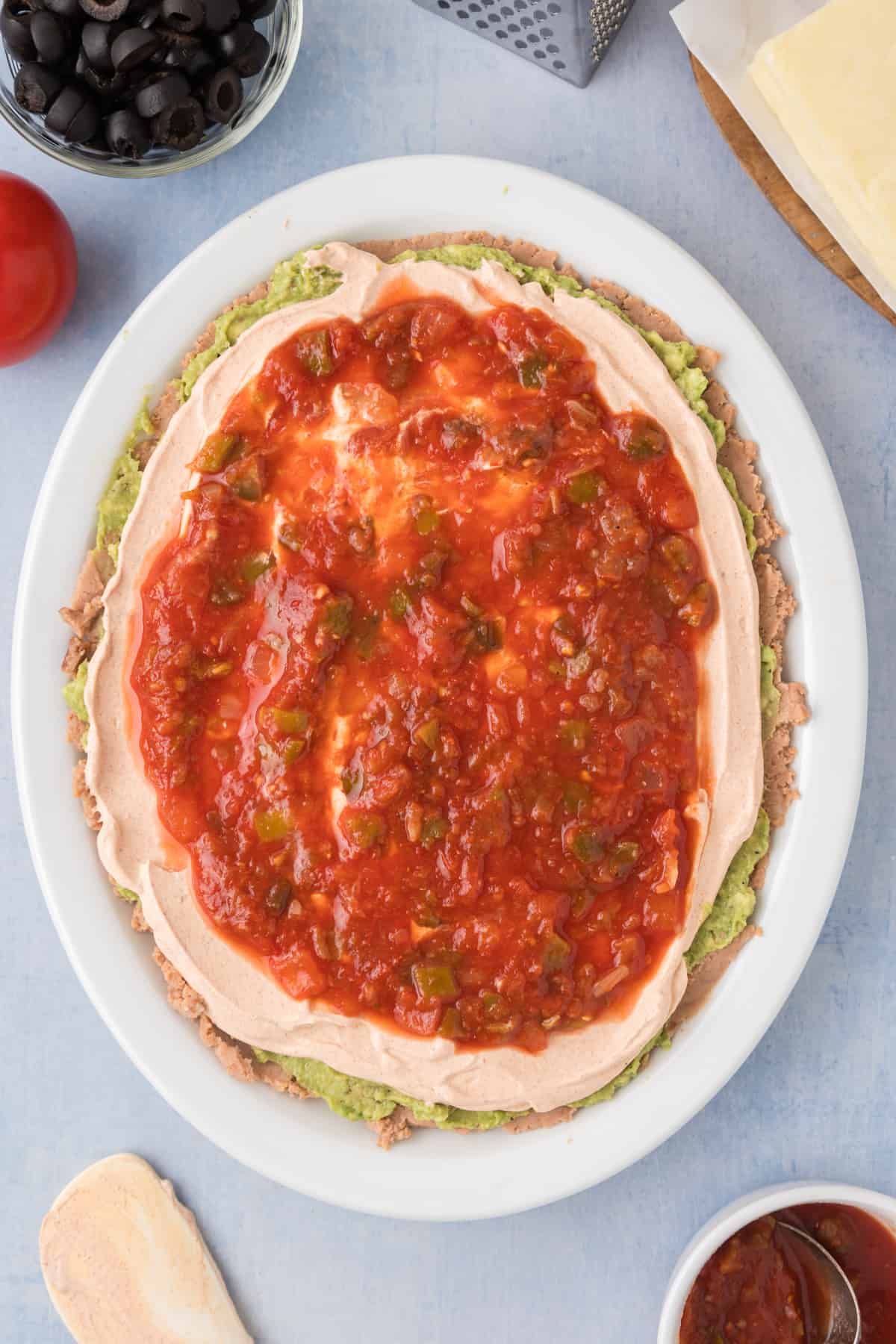 salsa spread on the sour cream layer for 7 layer dip
