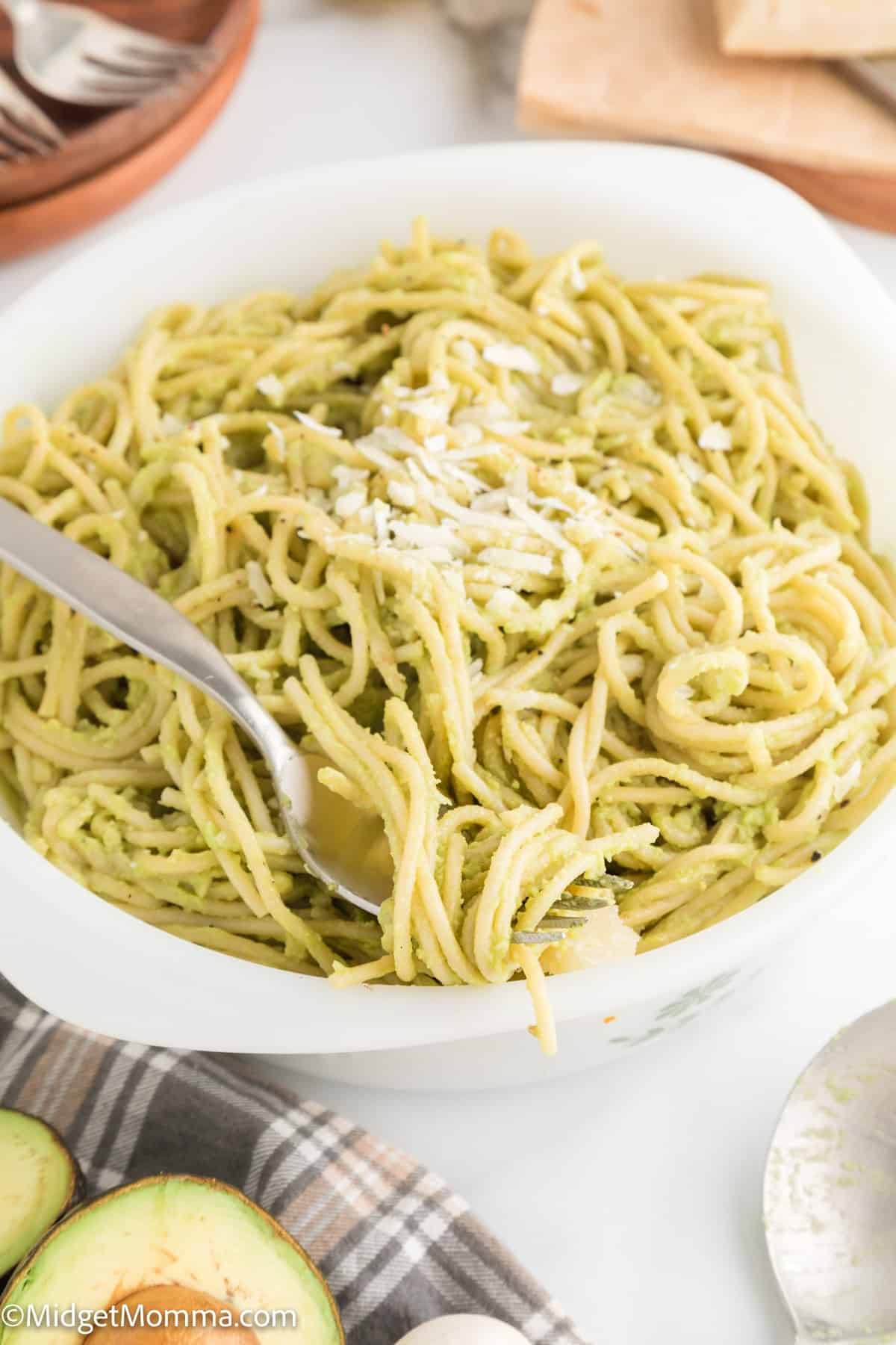 large bowl of Creamy roasted garlic avocado pasta sauce on top of pasta