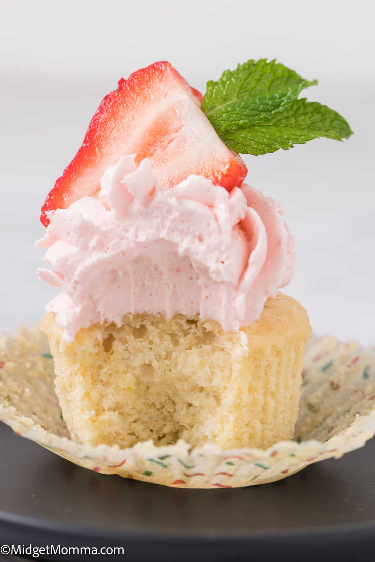Strawberry buttercream frosting recipe on top of a cupcake