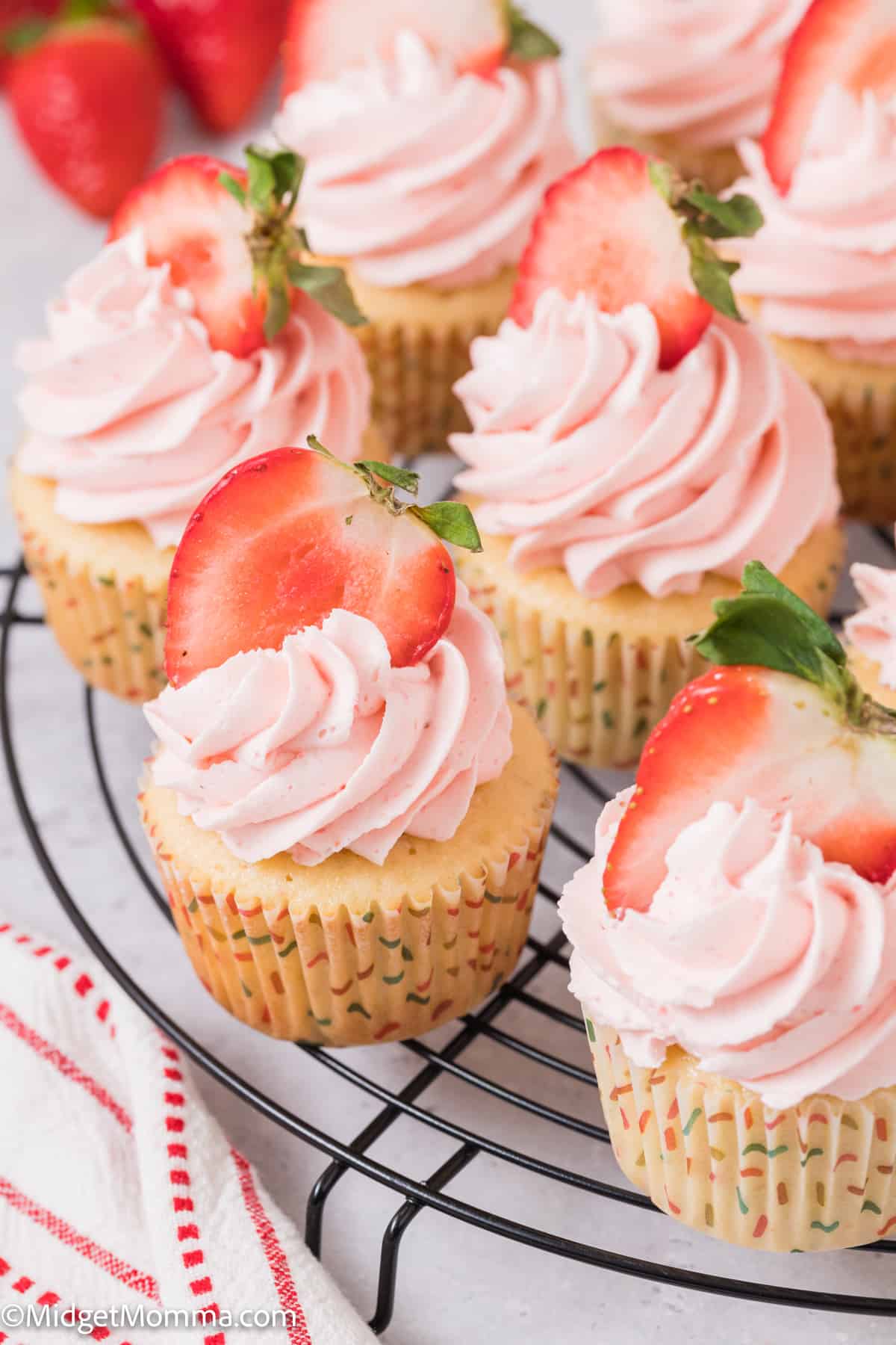 cupcakes topped with Strawberry buttercream frosting 